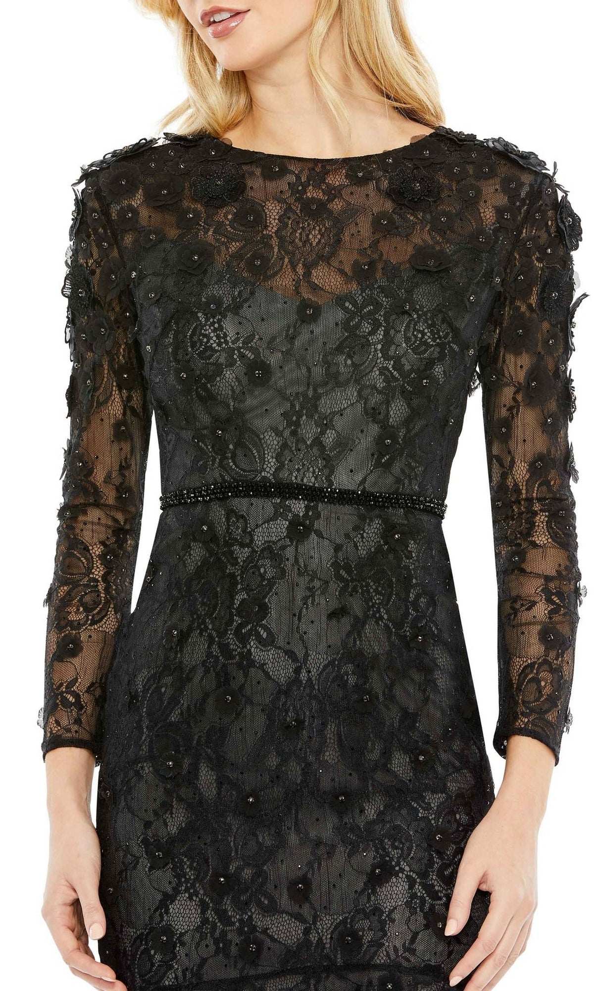 A woman stands with arms relaxed at her sides, wearing the Mac Duggal 67703 knee-length black party dress featuring long sleeves, lace fabric, and beaded details.